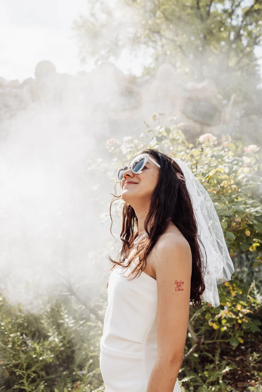 La mariée en bustier blanc et voile, le visage levé, dans un nuage de fumée blanche, EVJF à Bordeaux